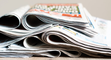 Different newspapers against newspaper background
