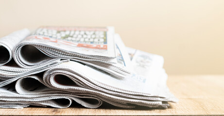 Different newspapers against newspaper background