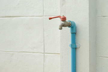 old faucet on concrete wall