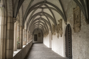 Naklejka premium Cloister of collegiate church showing vaulted ceiling and stone sculptures