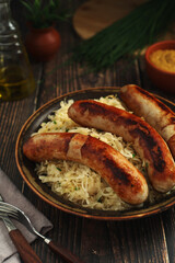 A bowl with Bratwurst and Sauerkraut as side dish - traditional German food