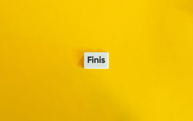 The End Word. Text on Block Letter Tile on Yellow Background. Minimal Aesthetic.