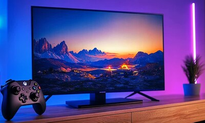 Stunning Landscape Displayed on Monitor in Cozy Setup with Gaming Console and Ambient Lighting Showcasing Nature's Beauty and Modern Technology - Powered by Adobe