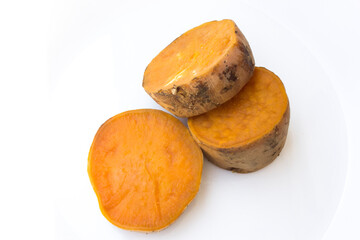 Sliced sweet potatoes isolated on a white background. The beta-carotene in sweet potatoes is crucial for maintaining good vision and overall eye health.