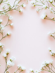 Naklejka premium soft floral background featuring delicate white flowers on light pink surface, perfect for invitations or greeting cards. gentle arrangement evokes serene and romantic atmosphere