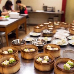 A Chinese restaurant specializing in dim sum, with carts rolling by tables offering a variety of small plates and dumplings