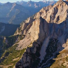 Fototapeta premium A full shot bird's-eye view of a dramatic mountain landscape, with deep focus on the layered ridges and valleys.