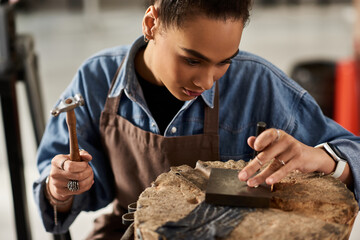 A talented jeweler meticulously shapes metal, showcasing artistry and dedication in her craft.