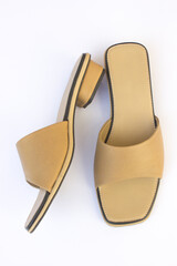 A brown women's open-toed sandal. These sandals are made of synthetic leather.