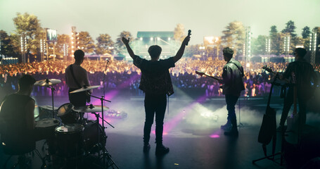 Rock Musicians in Fashionable Outfits Performing Alternative or Punk Rock Music on Festival Stage,...