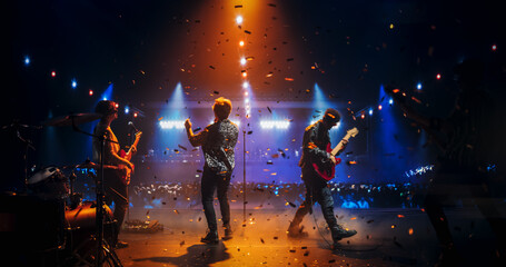 Professional Rock Musicians Performing a Live Set on Festival Stage, Playing Popular Rock Tracks in...