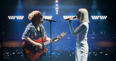 Pop Duo Collaboration With a Male Singer Playing Acoustic Guitar and Female Star Singing on Stage....