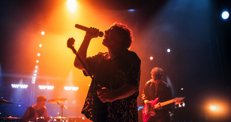 Portrait of a Stylish Lead Singer Performing at a Rock Concert Live on Stage. Talented Musician...