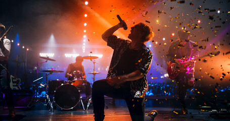 Rock Musicians in Fashionable Outfits Performing Alternative Punk Rock Music on a Nightclub Stage,...