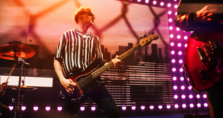Band Playing Hit Songs on Electric Guitars and Drums. Young Rock Musicians Performing a Live...