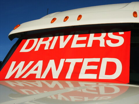 Drivers Wanted sign in  truck window.