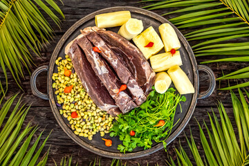 Traditional rustic tropical Brazilian dish, sun-dried beef with green beans, cassava, biquinho pepper. Creative rustic photography