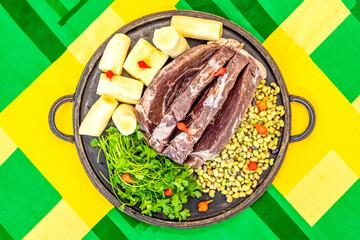 Traditional rustic tropical Brazilian dish, sun-dried beef with green beans, cassava, biquinho pepper. Creative rustic photography