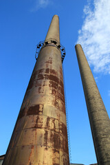 Tall, metal industrial smokestack