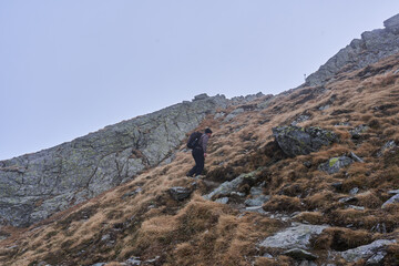 Man hiking in a cold day in the rocky mountains