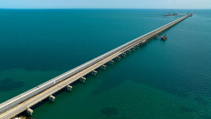 Aerial view of a long jetty on the Mediterranean Sea.