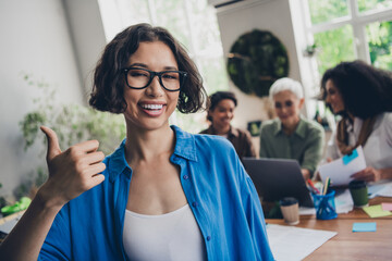 Portrait of team ambitious business women show thumb up cooperate modern interior office indoors