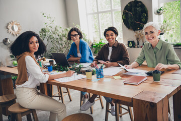 Portrait of team ambitious business women cooperate project desk modern interior office indoors