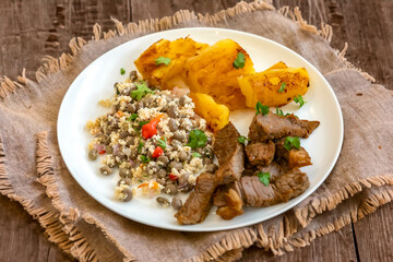 Traditional rustic tropical Brazilian dish, sun-dried beef with green beans, cassava, biquinho pepper. Creative rustic photography