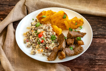 Traditional rustic tropical Brazilian dish, sun-dried beef with green beans, cassava, biquinho pepper. Creative rustic photography
