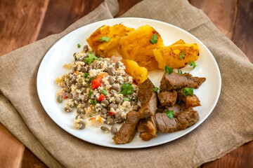 Traditional rustic tropical Brazilian dish, sun-dried beef with green beans, cassava, biquinho pepper. Creative rustic photography