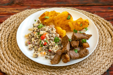 Traditional rustic tropical Brazilian dish, sun-dried beef with green beans, cassava, biquinho pepper. Creative rustic photography