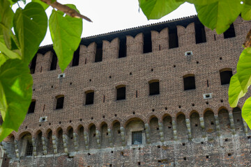 Obraz premium the famous historic castle castello sforzesco in Milan, Italy. At a sunny summer day with green park area 