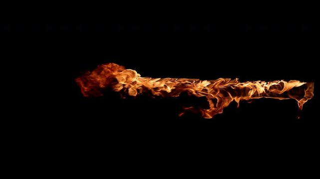 Fire spreading creating a trail of flames on black background
