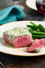 Sliced rare steak with blue cheese sauce