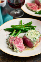 Sliced rare steak with blue cheese sauce