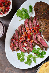 Skirt steak sliced on the plate with pico de gallo