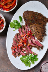 Skirt steak sliced on the plate with pico de gallo