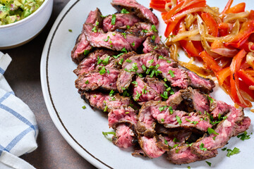 Skirt steak with peppers, corn tortillas, guacamole and pico de gallo