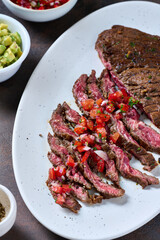 Skirt steak sliced on the plate with pico de gallo