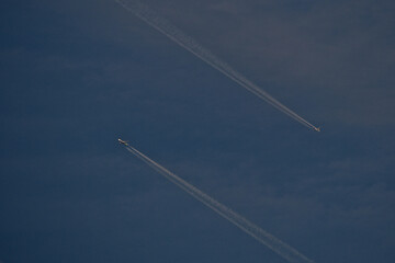 Airplane trails in the blue sky, contrails.