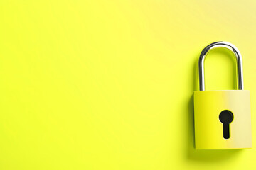 A Bright Yellow Padlock Rests Against a Vivid Yellow Background, Symbolizing Security and Safety