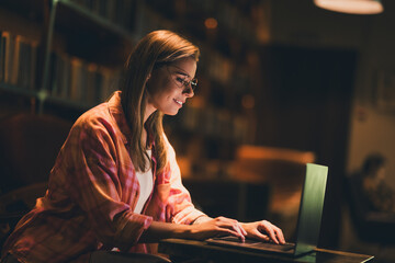 Photo of attractive young blonde woman working computer wear plaid shirt study comfortable dark...