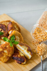 cooked fried pea pies on a wooden board
