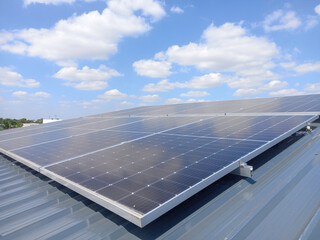 large array of solar panels installed on a rooftop. The solar panels are arranged in rows and are...