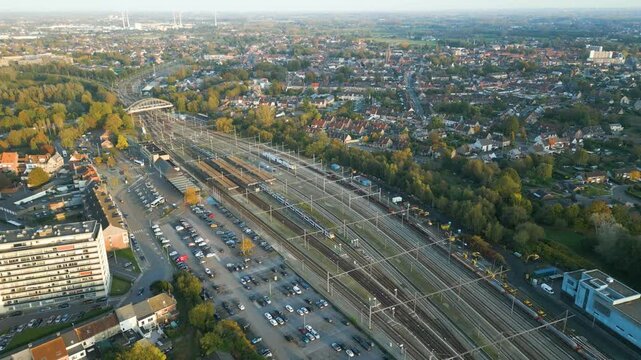 dendermonde railway station trains tracks against sunny backdrop sint gillis bij importance public backward aerial drone shot view footage 