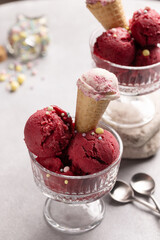 Red raspberry ice cream balls in a creamer