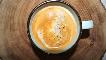 Cup of coffee on the wood background