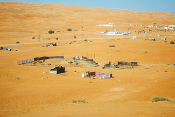 Obraz premium Golden desert sand dunes. Muscat, Oman’s port capital, sits on the Gulf of Oman surrounded by mountains and desert.