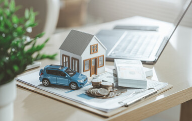 estate, financial, loan, investment, increase, insurance, investing, management, mortgage, property. A blue car sits on top of a stack of money and coins. Concept of wealth and success.