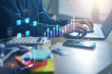statistic, analysis, plan, report, growth, chart, diagram, document, graph, graphs. A man is typing on a laptop with a screen displaying graphs and numbers. as the man is working on data or financial.